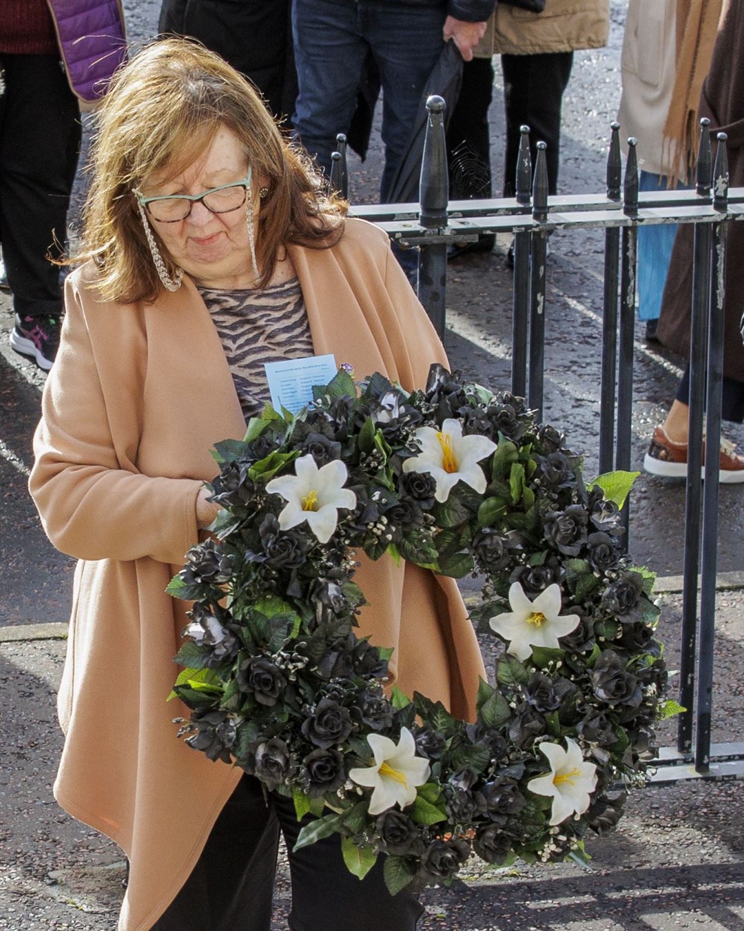 Dympna Kerr, the sister of Columba McVeigh, lays the wreath during the 17th annual All Souls Silent Walk for the Disappeared at Stormont (Liam McBurney/PA)