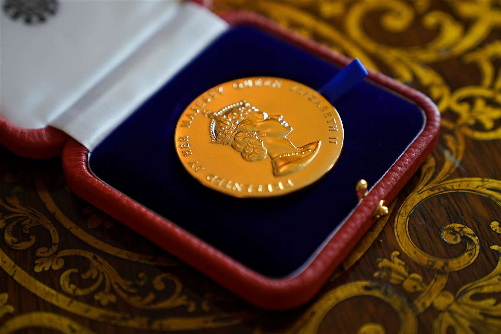 The Queen said the Queen’s Gold Medal for Poetry, which was presented to David Constantine, was ‘rather a nice medal’ (Kirsty O’Connor/PA)