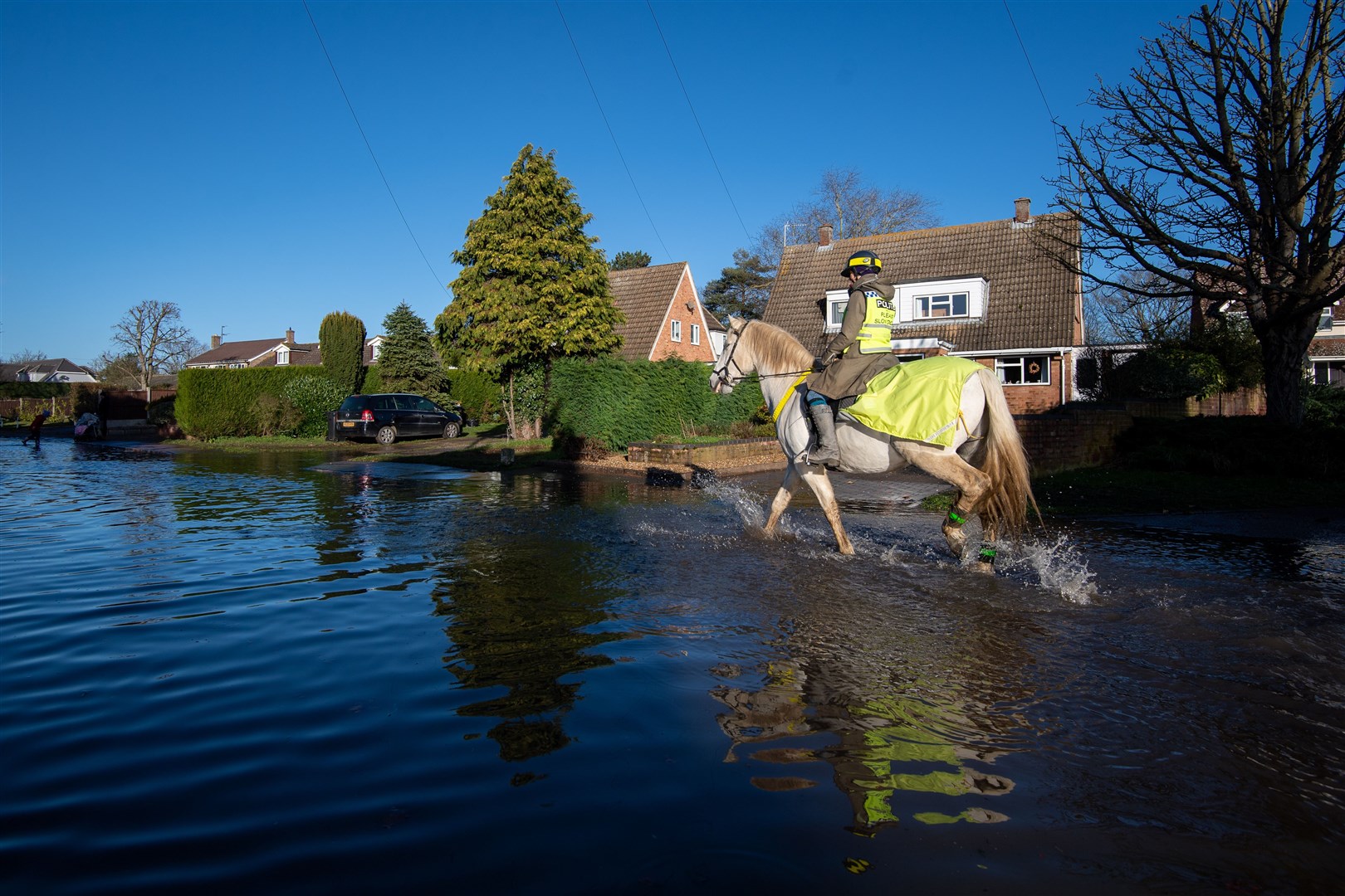 A woman rides a horse through flood water in Bedfordshire (Joe Giddens/PA)