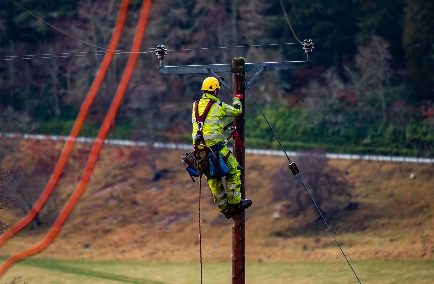 A SSEN engineer working on upgrading power lines near Tomatin. Photo: Stuart Nicol Photography