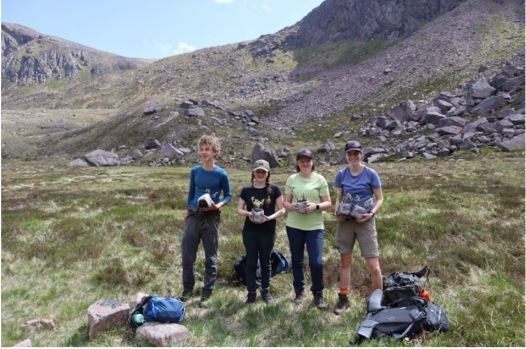 Members of the Cairngorms National Park Junior Rangers holding the willow saplingsthey carried to the Loch A’an basin on this year’s willow walk. ©Cairngorms Connect