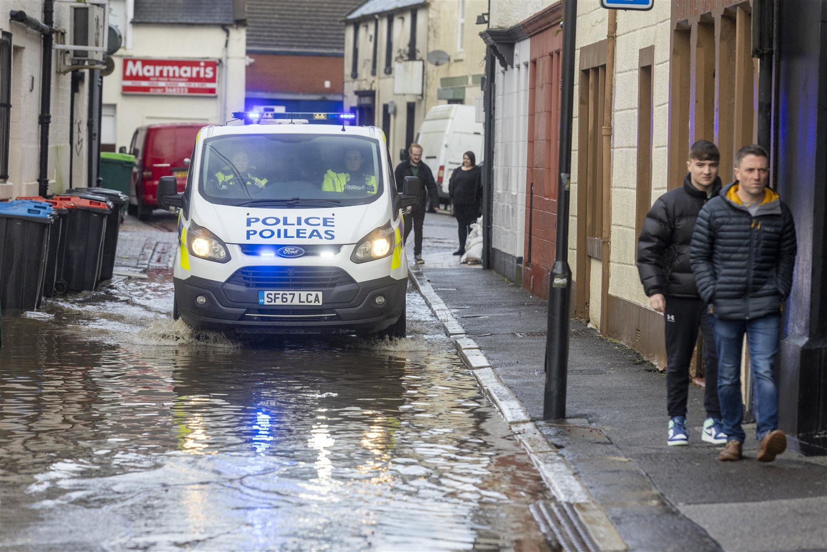 A police vehicle negotiates flooded roads in Whitesands, Dumfries (Robert Perry/PA)