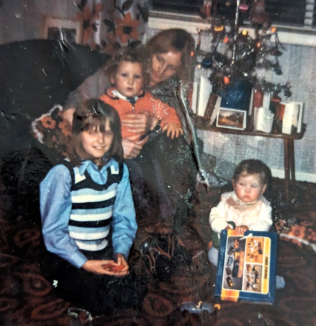 Sandy sitting on his father’s knee, with his auntie and sister Donna nearby (family handout/Police Scotland/PA)