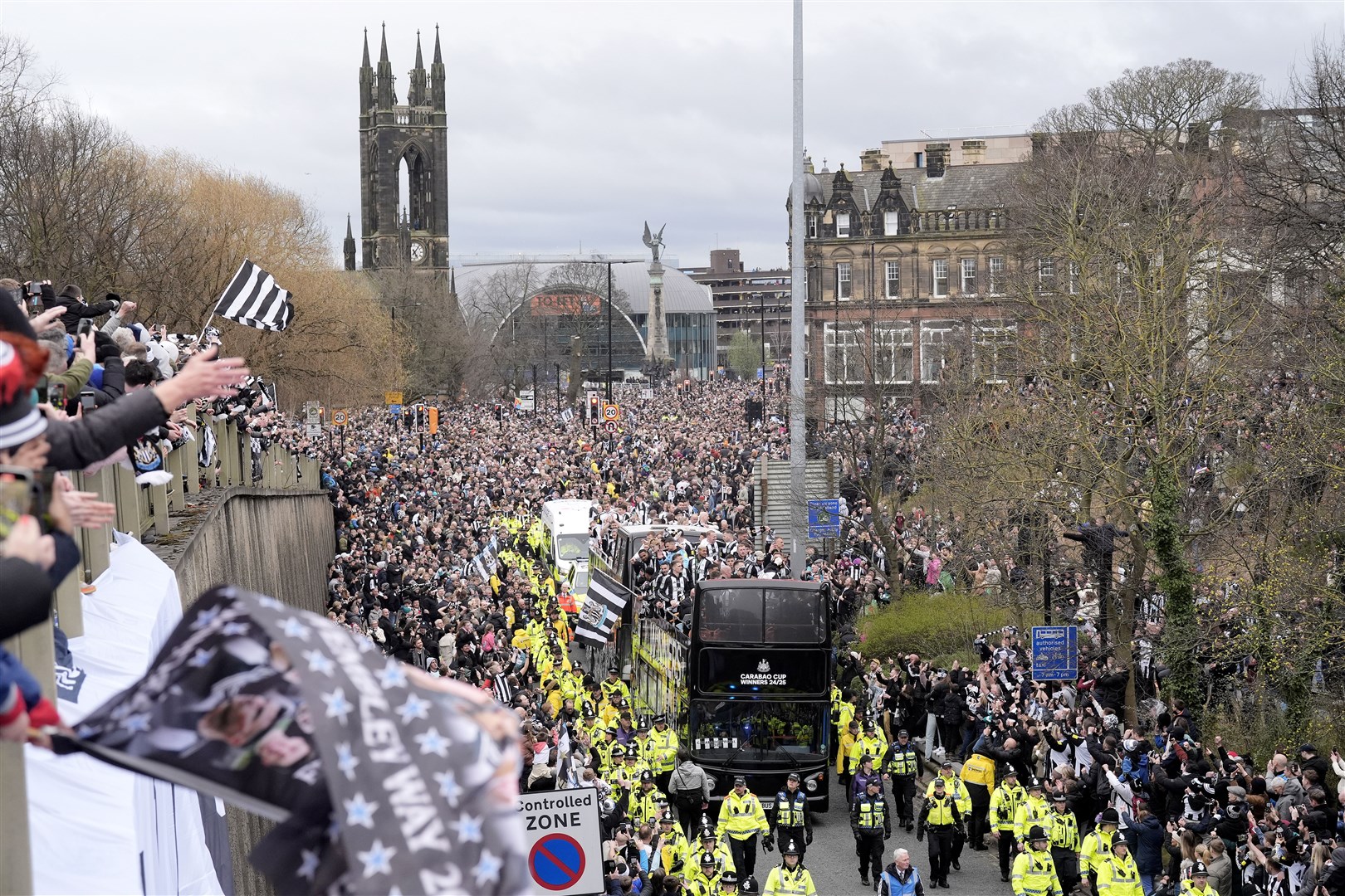 Newcastle United fans watch on as the players pass by aboard an open top bus during the Carabao Cup trophy parade (Danny Lawson/PA)