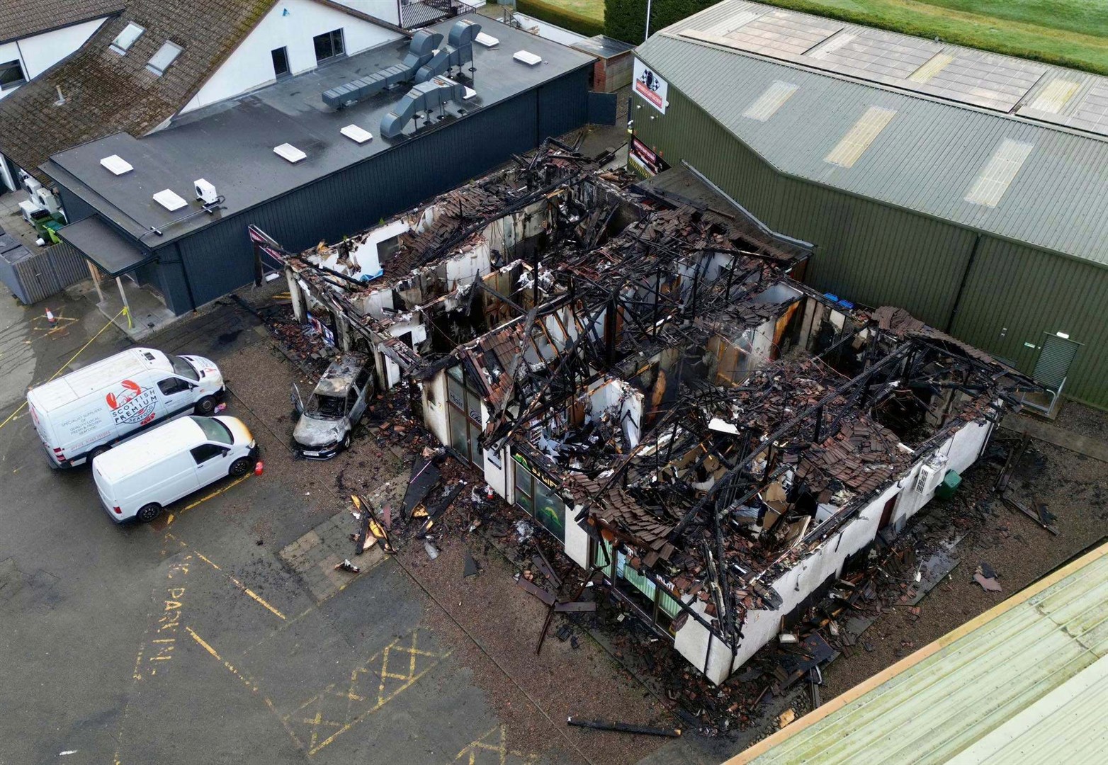 Drone footage reveals the scale of the damage and how close it came to neighbouring buildings. Picture: Walter Geddes.