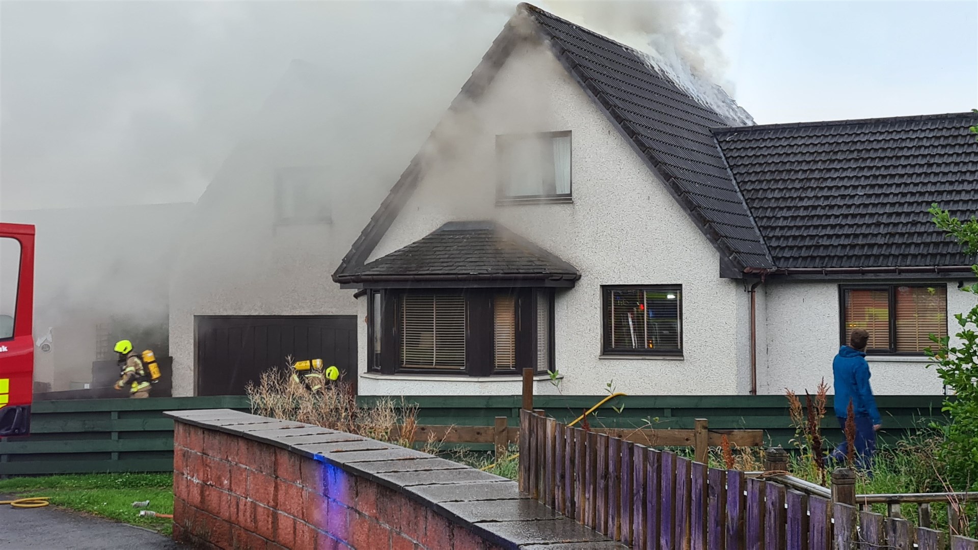Smoke continues to pour from the property.