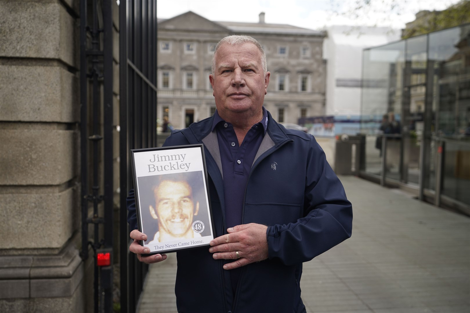 Errol Buckley holds a photo of his brother Jimmy Buckley, who died in the fire, as he arrives at Leinster House, Dublin (Niall Carson/PA)