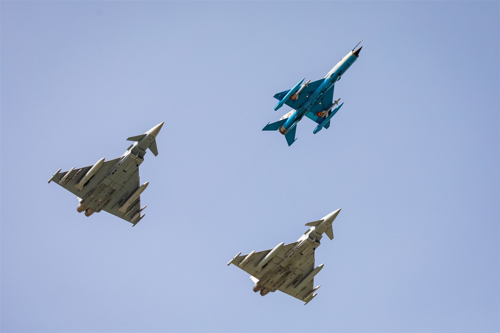 The first live-armed international Quick Reaction Alert practice scramble comprised of a Romanian Air Force MiG 21, a Royal Air Force Typhoon, and a German Luftwaffe Eurofighter.