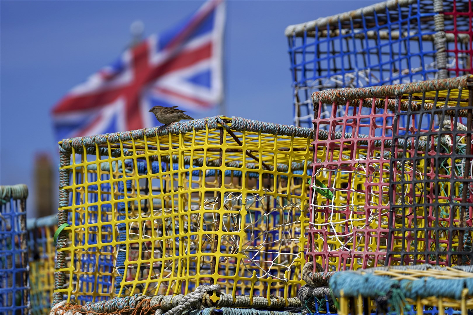 Empty fishing nets sit on the beach at Hastings, Sussex (Steve Parsons/PA)