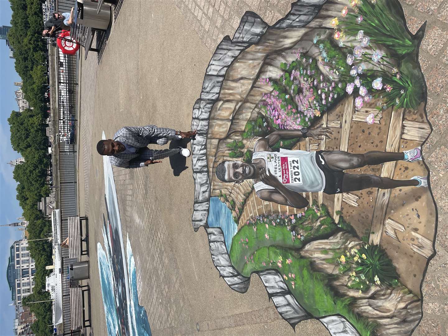 The street art, created by 3D Joe and Max, tells the story of how Ethiopian Eskander Turki sought refuge in the UK and found healing through running (Migrant Help/PA)