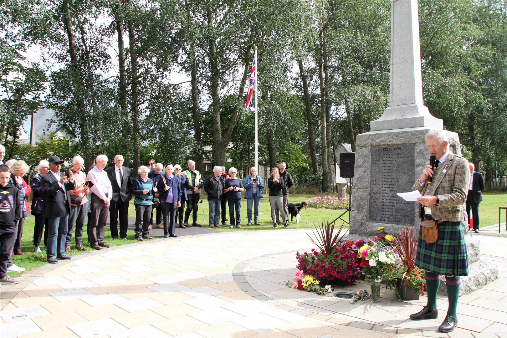 Deputy Lieutenant Fergus Laing welcomes the crowd to Kingussie's War Memorial today