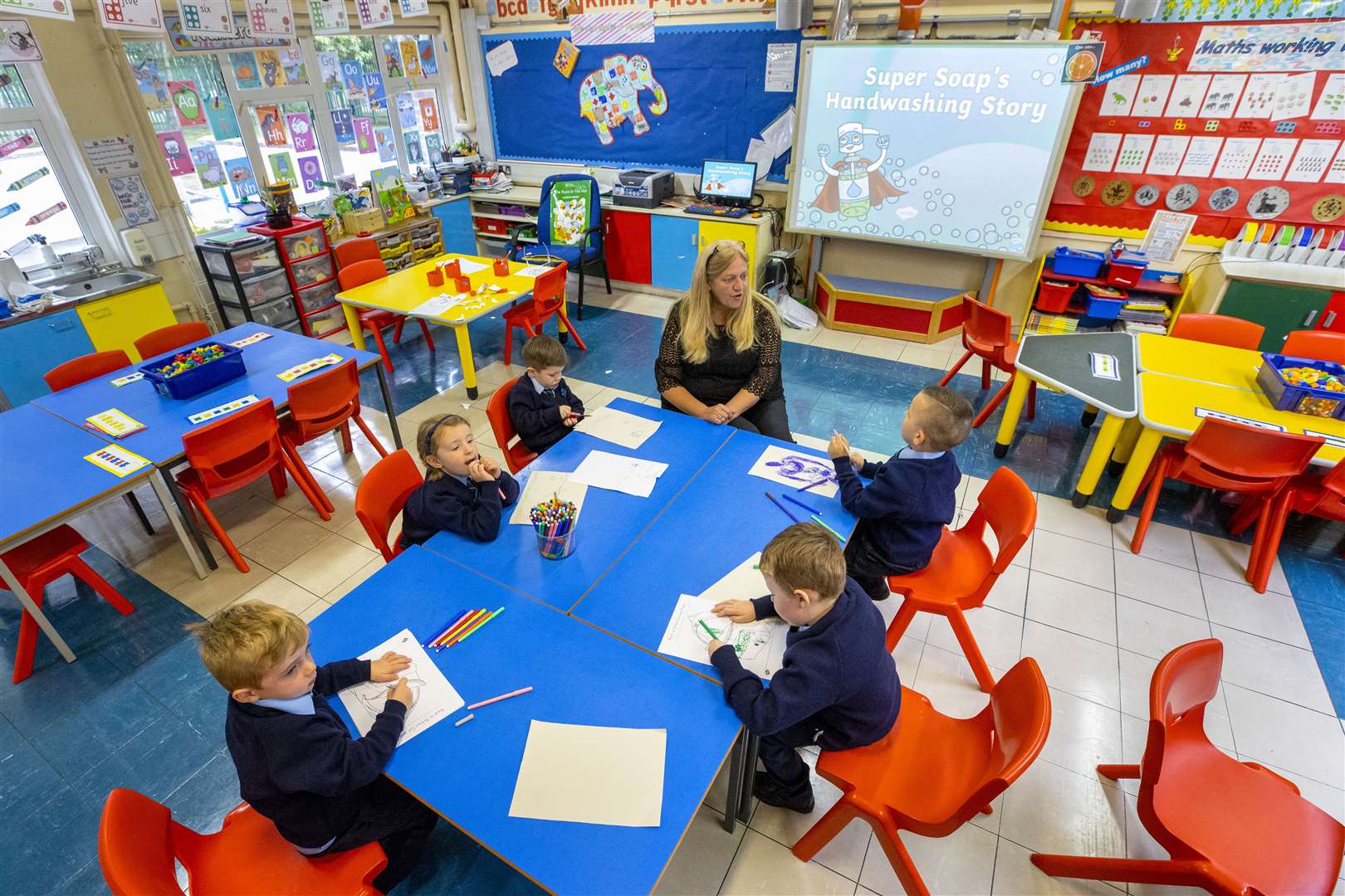Teacher Joanne Conlon with some of her class pupils on their first day of P1 at St John the Baptist Primary School in west Belfast (Liam McBurney/PA)