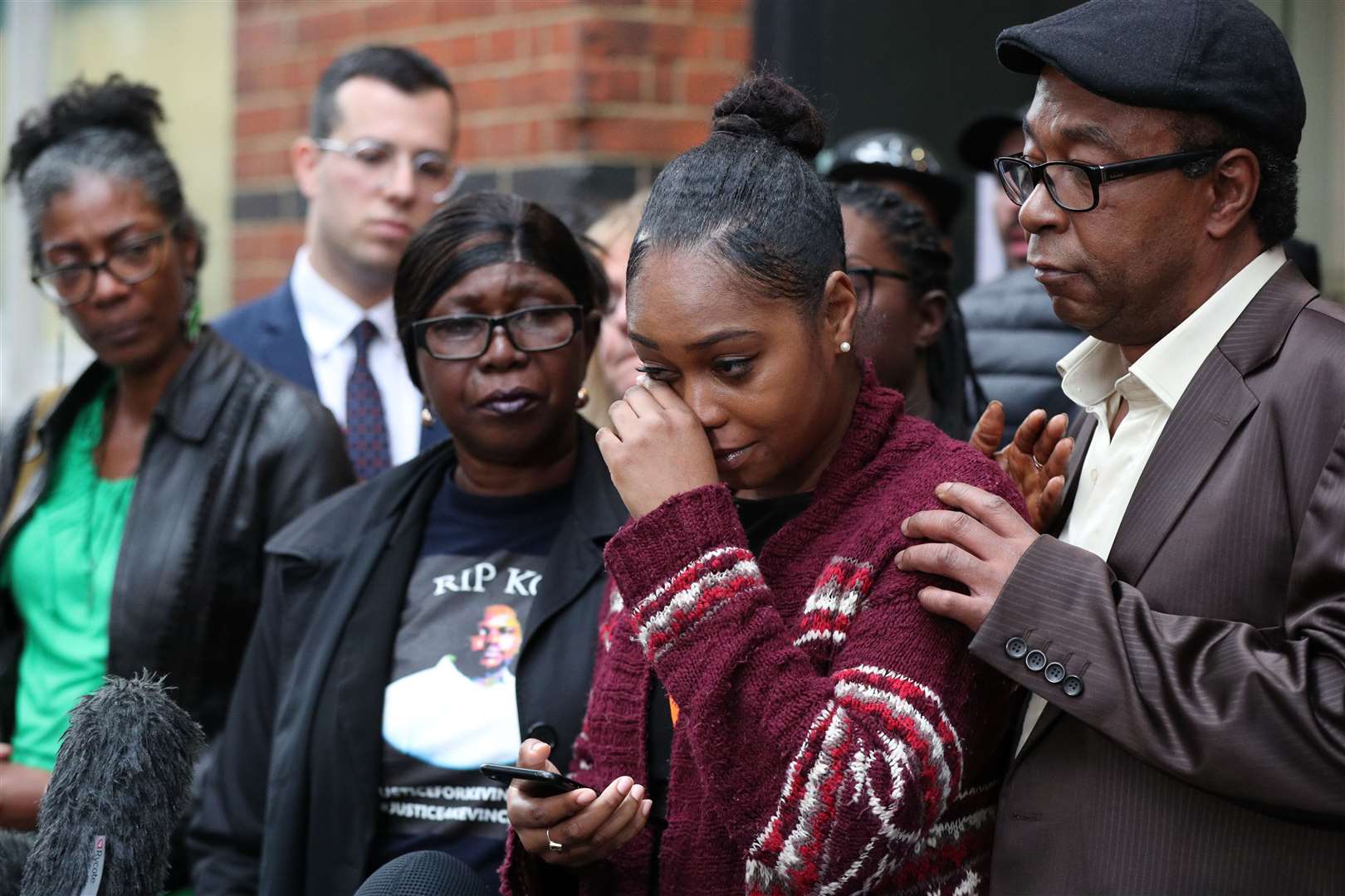 Wendy Clarke (second left) and Tellecia Strachen (second right), the mother and sister of Kevin Clakre, address the media (Jonathan Brady/PA)