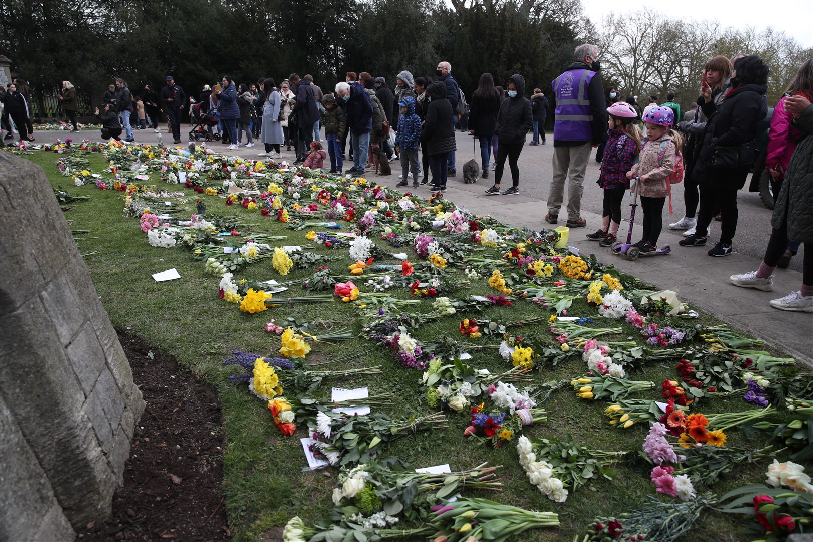 Some flowers have been left outside Windsor Castle following Philip’s death (Steve Parsons/PA)