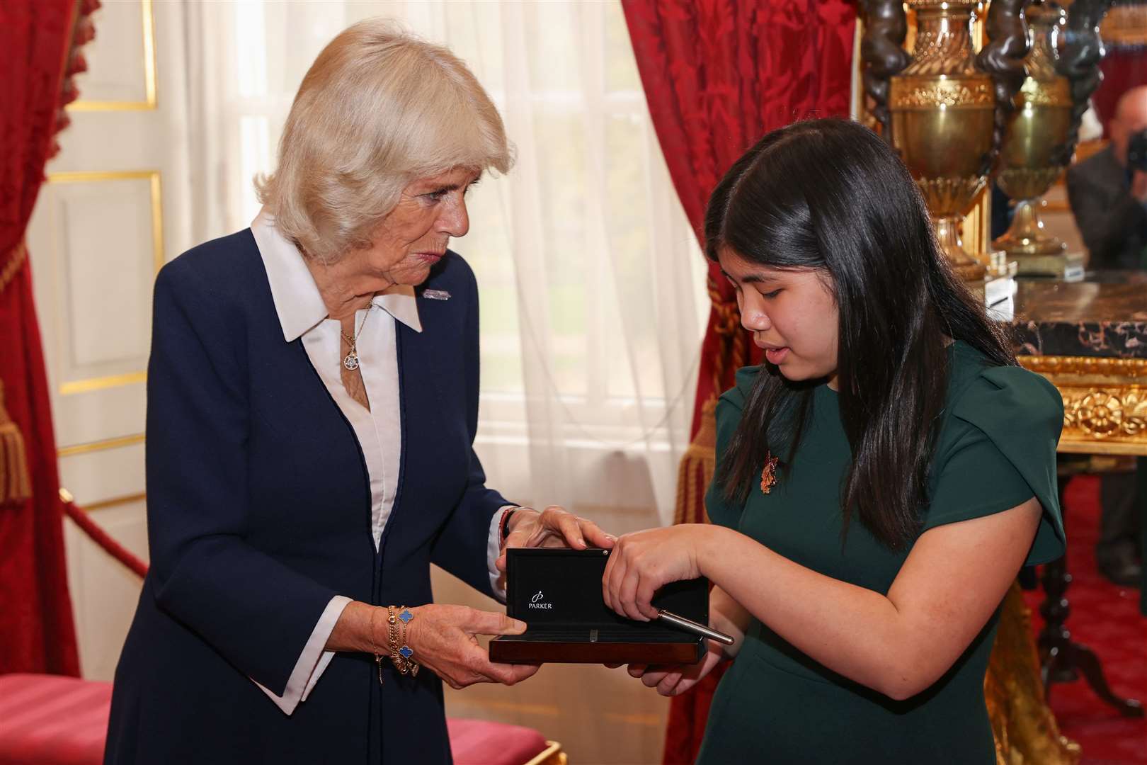 The Duchess of Cornwall presents Junior Winner from 2020, Cassandra Nguyen with a pen during the awards ceremony (Chris Jackson/PA)