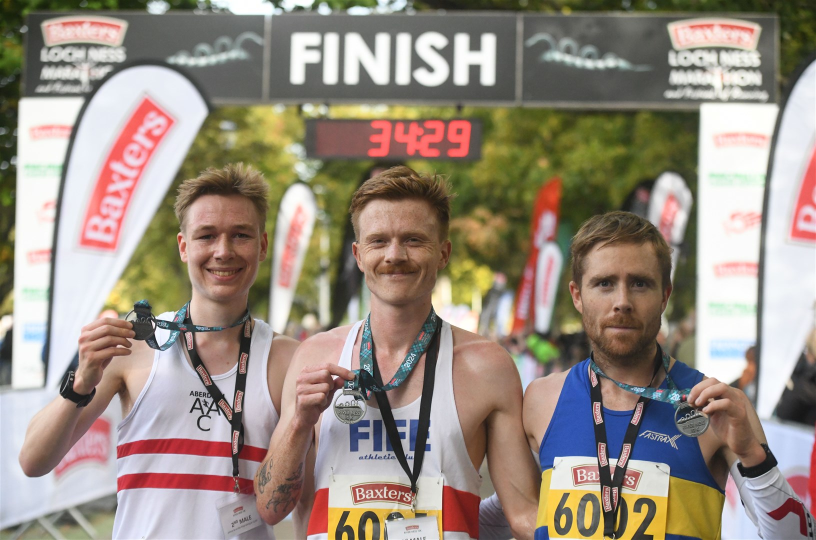 Logan Rees (centre) won the River Ness 10k with Max Abernethy (left) second and Lachlan Oates (right) third. Picture: James Mackenzie