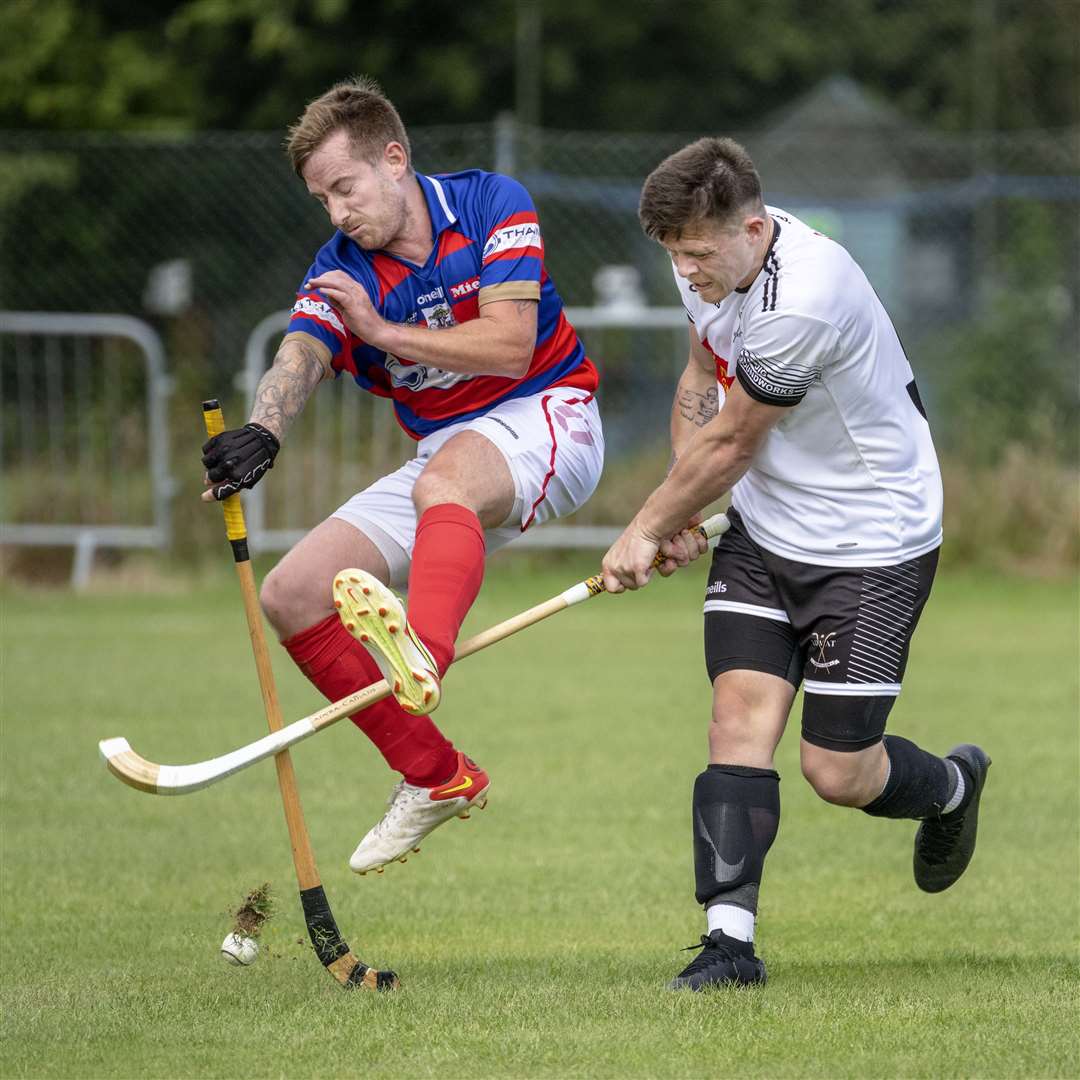Kingussie's Fraser Munro getting a block in on Martin Mainland (Lovat) in the Artemis MacAulay Cup semi final (North).