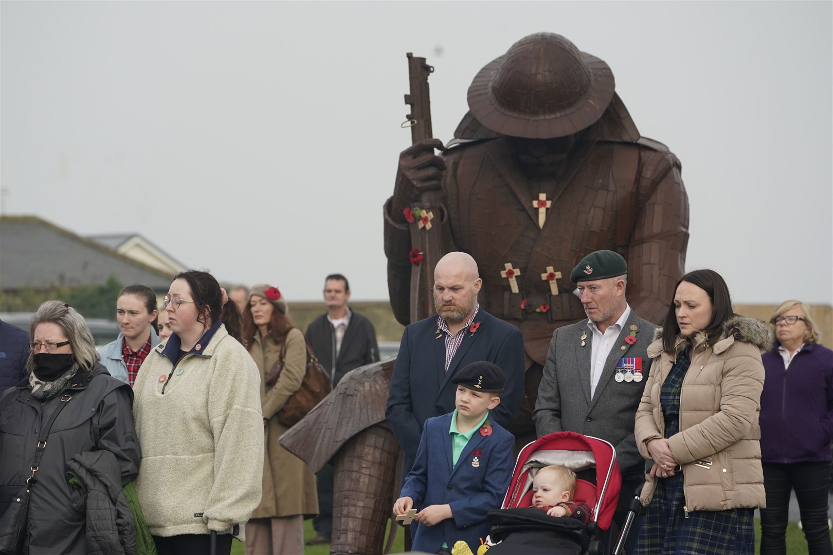 Paying tribute at the Tommy statue (Owen Humphreys/PA)