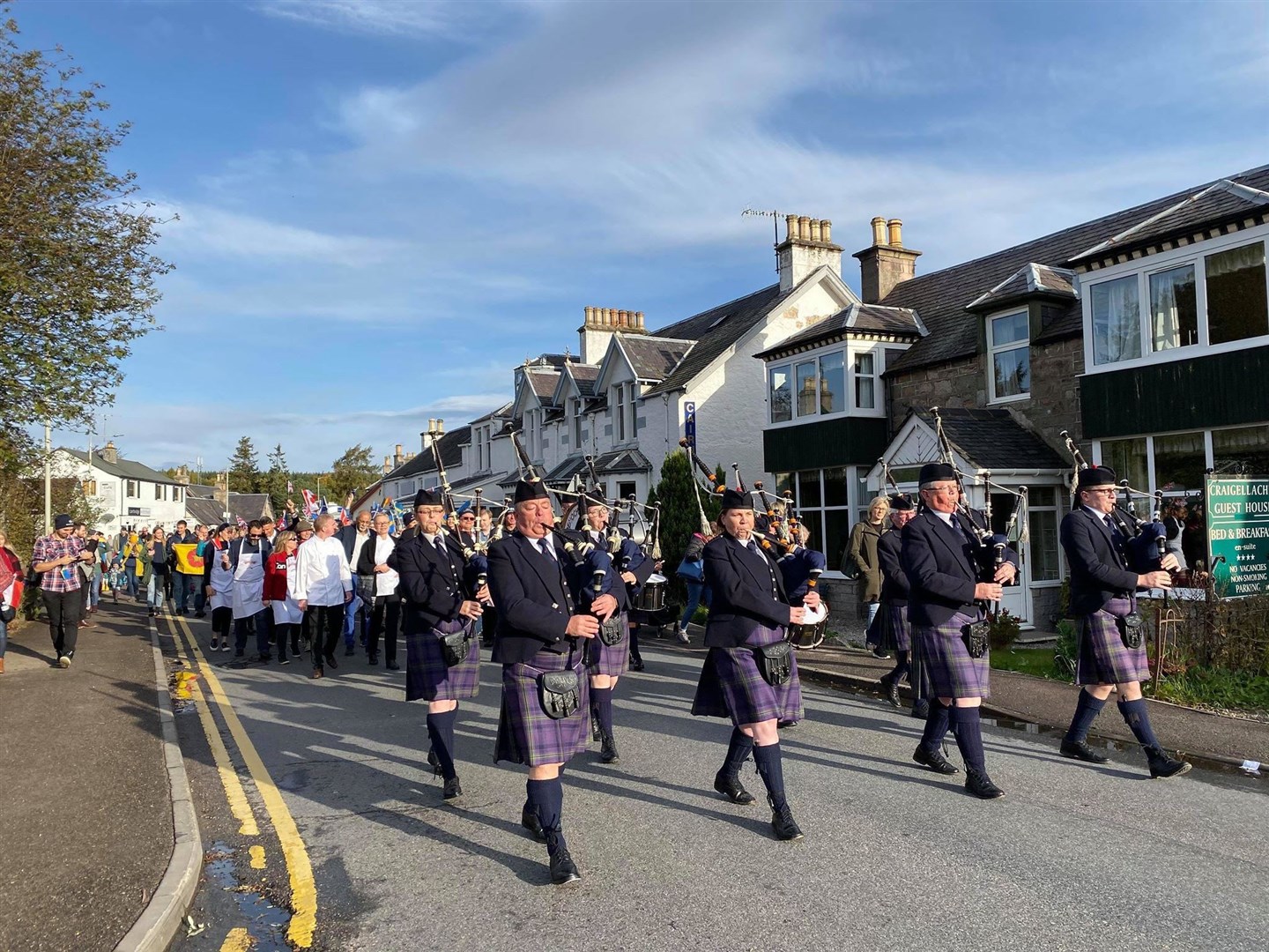 Badenoch and Strathspey Pipe Band leads the competitors, judges and spectators to the village hall for the 2019 World Porridge Champs in Carrbridge.