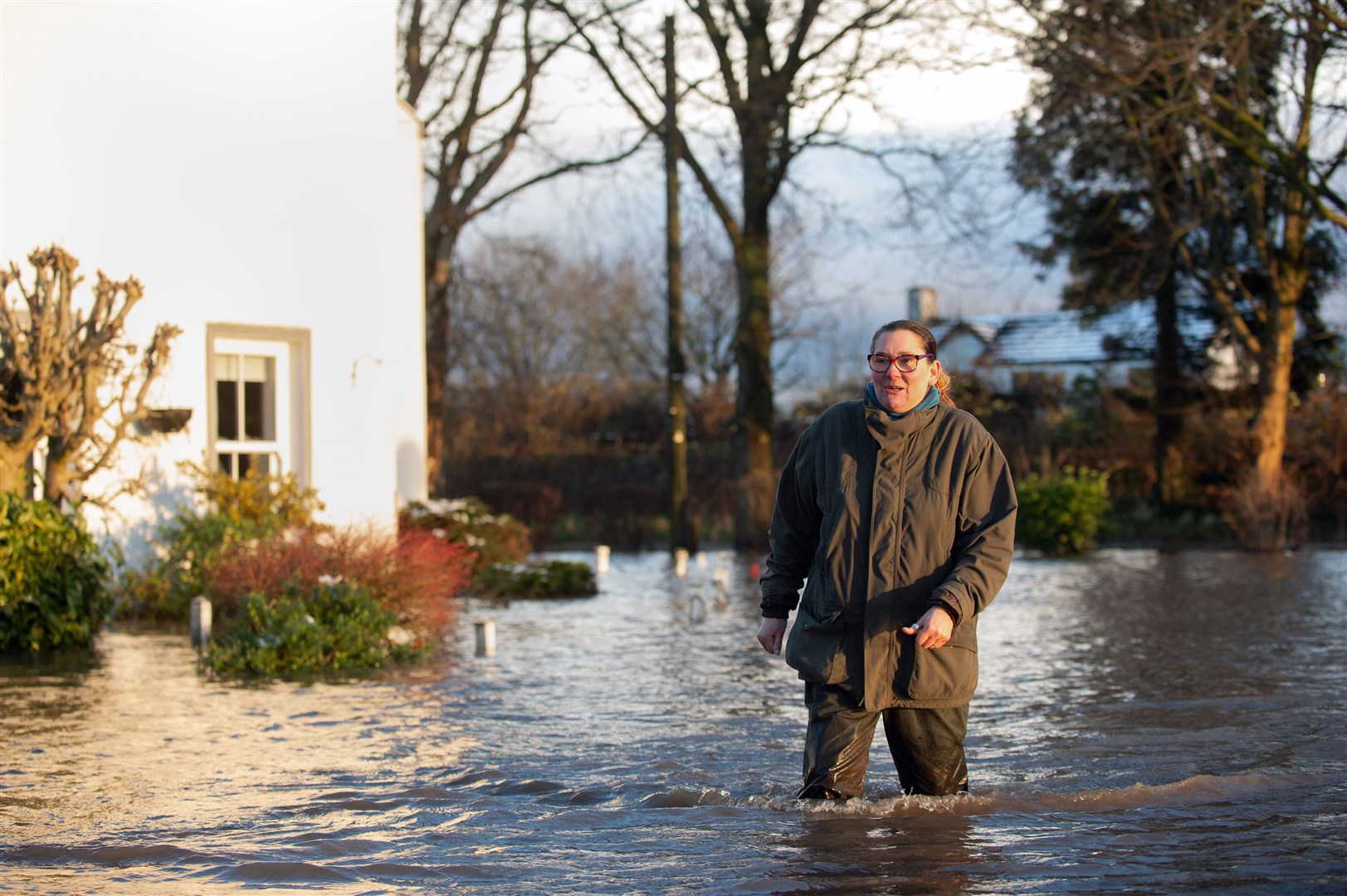 Gabrielle Burns-Smith outside her flooded home on the outskirts of Lymm (Joe Giddens/PA)