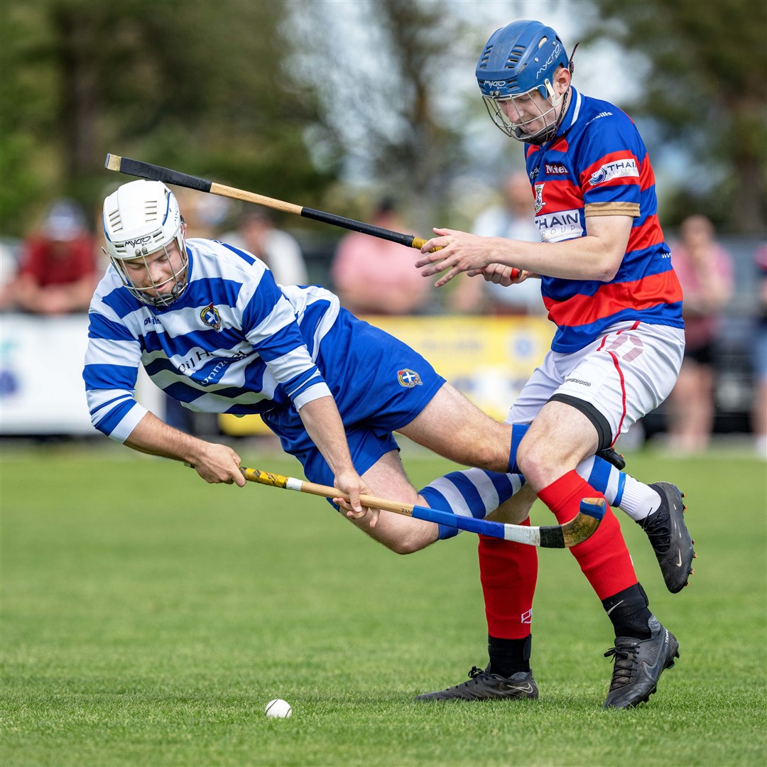 A flying Iain Robinson (Newtonmore) with Robert Mabon (Kingussie). Newtonmore v Kingussie in the cottages.com MacTavish Cup semi final, played at The Eilan, Newtonmore.