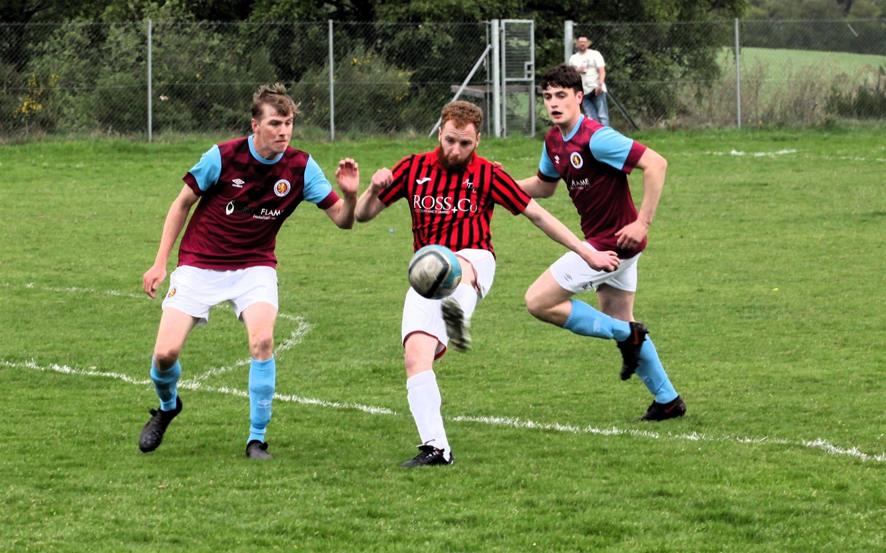 Thistle's player-manager Finlay McDonald controls the ball as Matt Reynolds (left) and Kalen Clark look on for Grantown Utd