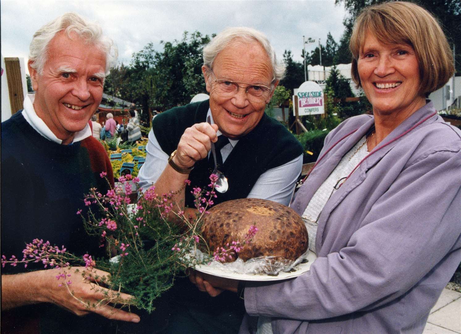 David and Betty sampling the famous Clootie Dumpling with Jim McColl of Beechgrove Garden fame at a fundraising day.