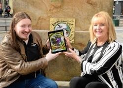 The eighth and final HighlandAR plaque is unveiled at Falcon Square by app creator Darroch McNaughton and Eastgate Centre manager Jackie Cuddy.