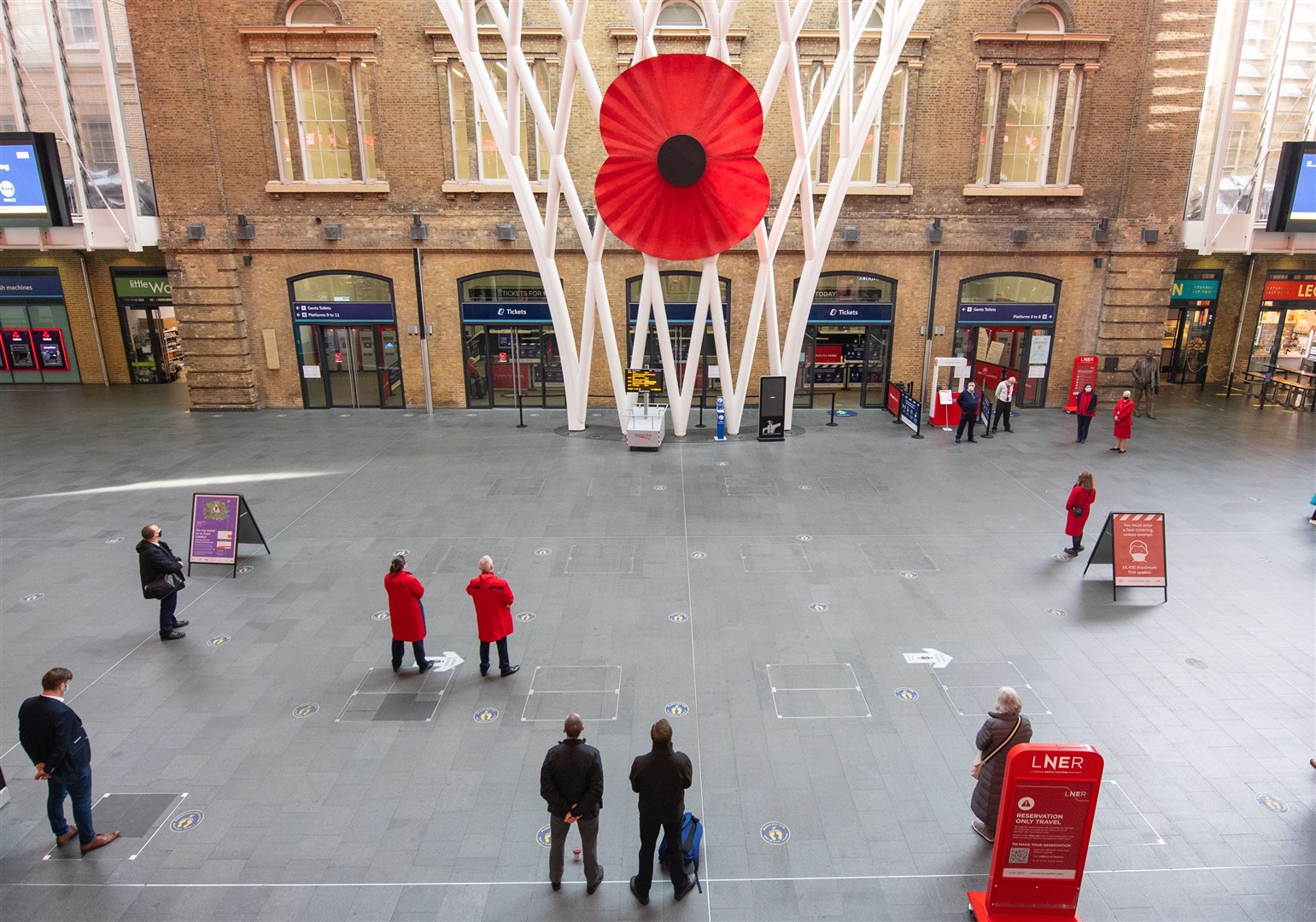 People observe a two-minute silence at King’s Cross station, London (Dominic Lipinski/PA)