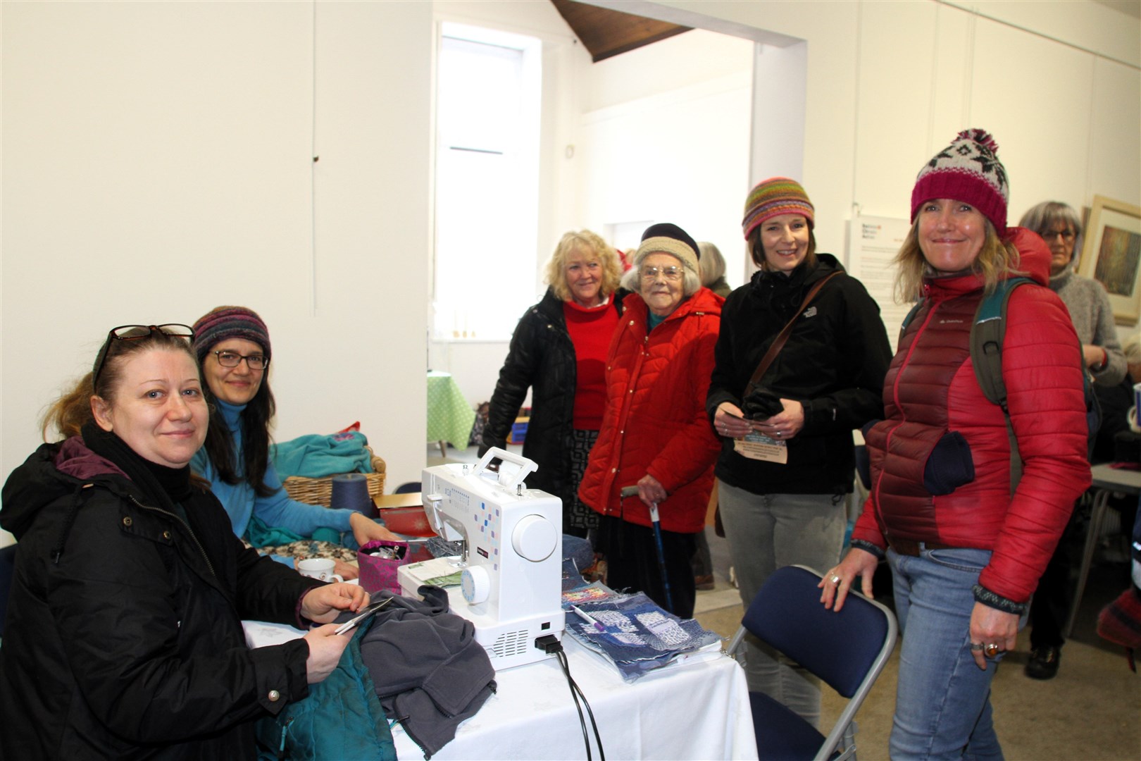 IN GOOD REPAIR: Repair Cafe Cairgorms volunteers Claire Macdonald (back left) and Iryna Yednak (front left) with visitors to their table.