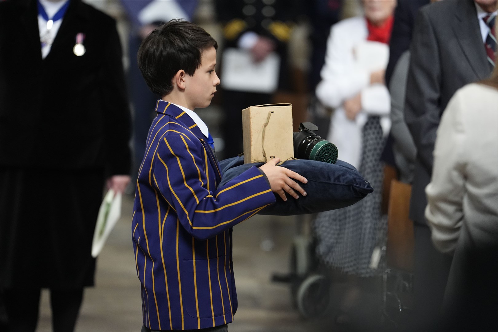 A child’s gas mask and box is carried to the High Altar in Westminster Abbey (Jordan Pettitt/PA)