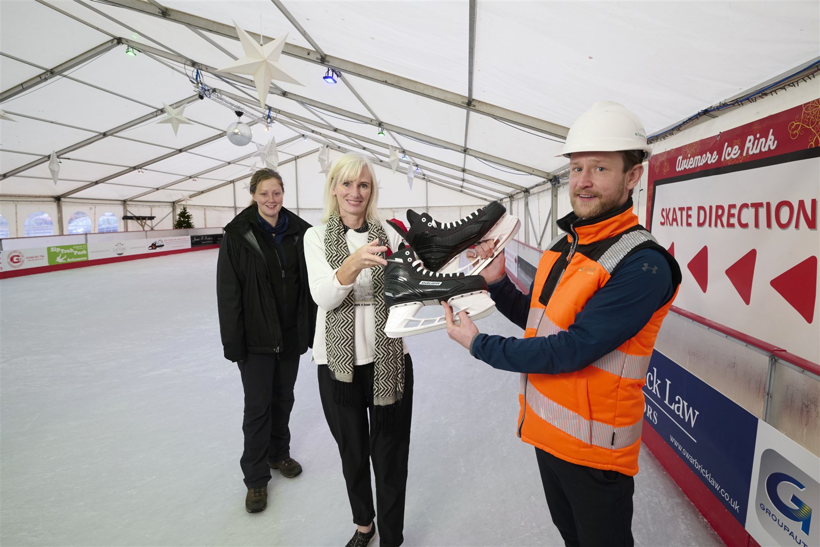 Rink manager Amanda Clinton, Kirsty Bruce and Zander Sutherland. 2/3) Kirsty Bruce offers Zander the chance to try out the rink