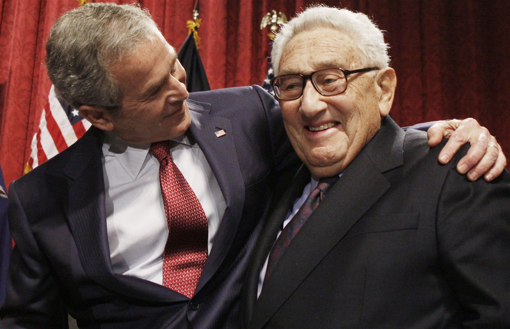 Former president George W Bush, left, stands with former secretary of state Henry Kissinger (Charles Dharapak, AP File)