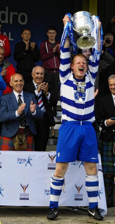 Man of the match Robinson lifts the famous trophy