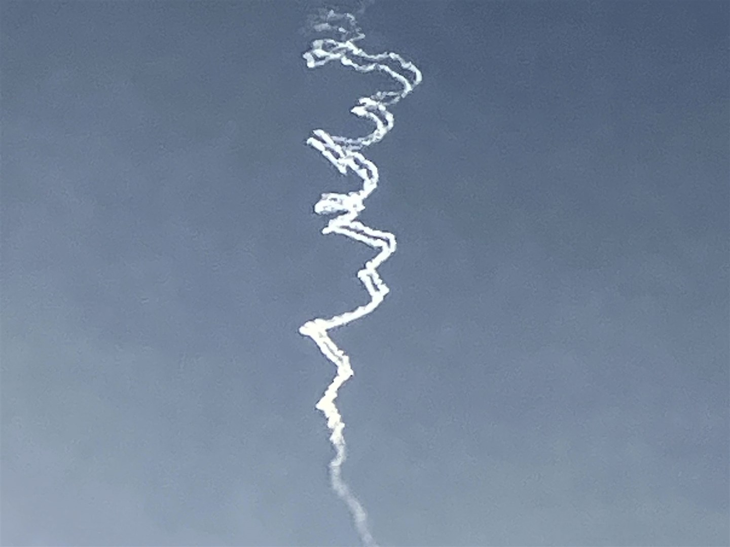 Smoke trails from Israeli air defence system are seen in the sky as it intercepts missiles launched during an Iranian attack on Tuesday (Ariel Schalit/AP)