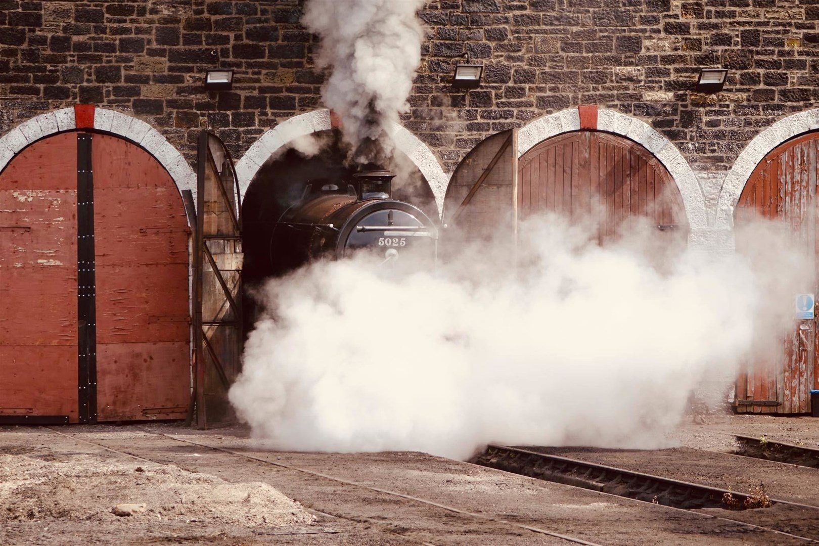 LMS 5025 re-emerges from the distant past through the steam at Aviemore (David MacLeod)