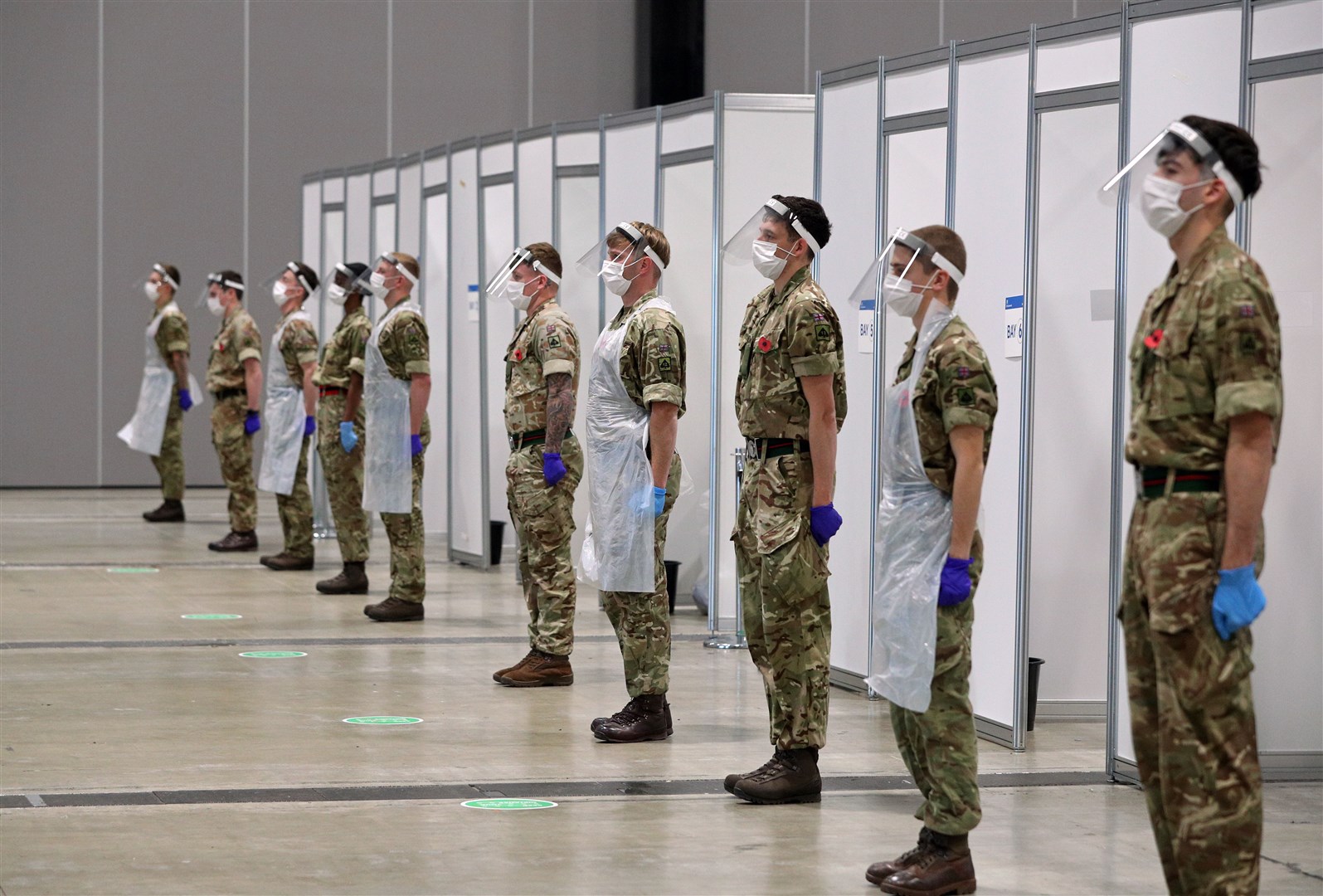 Soldiers helping with the mass Covid testing in Merseyside stand in tribute at the Arena Convention Centre in Liverpool (Peter Byrne/PA)