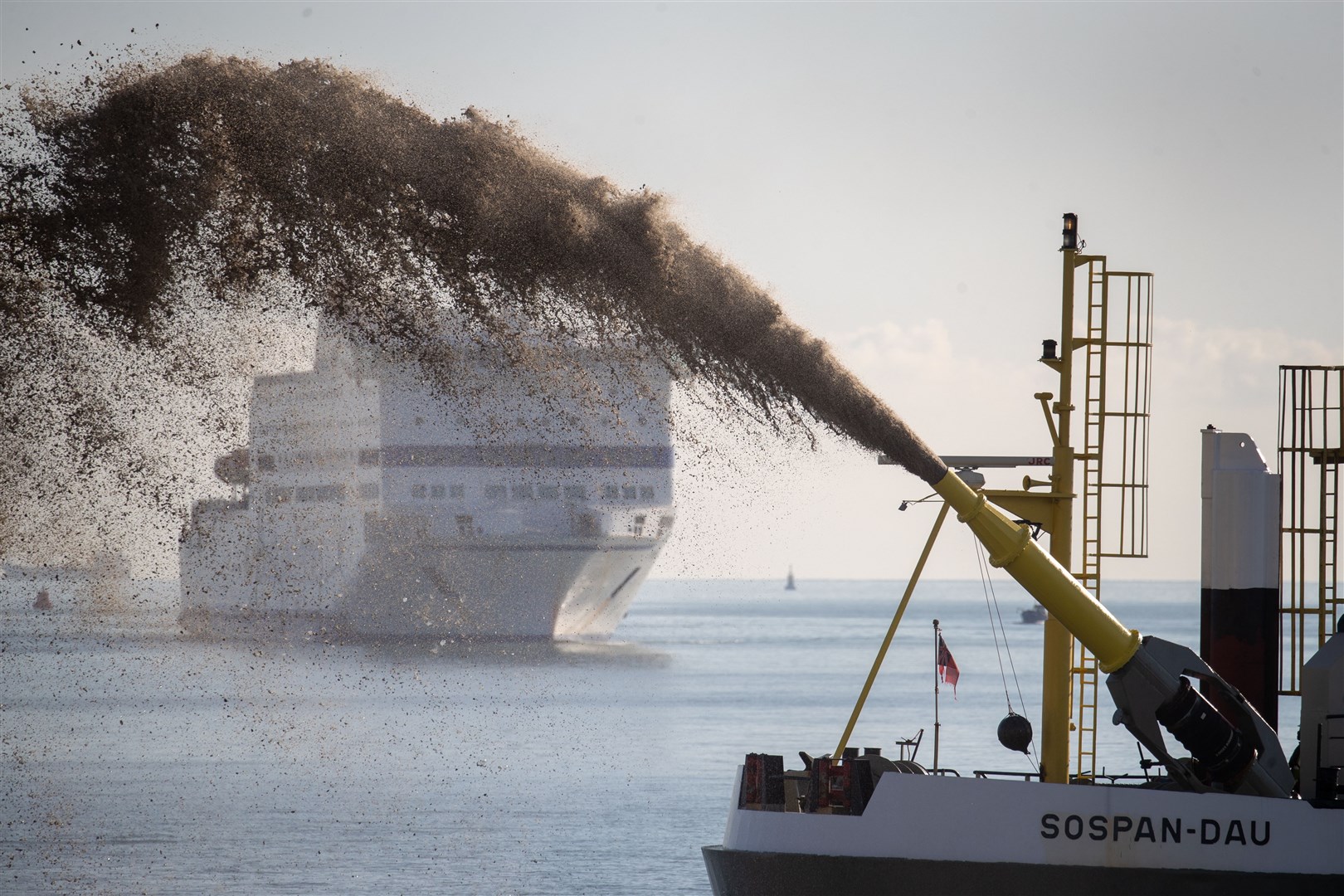 The dredger Sospan Dau sprays gravel on to the foreshore of Portsmouth seafront to develop a temporary working platform for a £100m sea defence scheme (Andrew Matthews/PA)