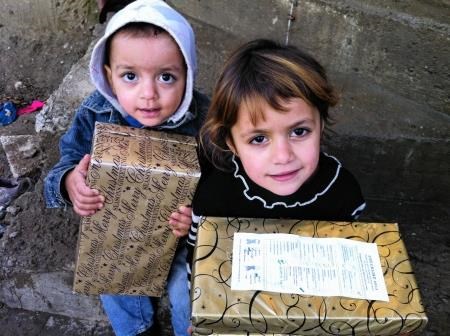 Two children in Kosovo with their boxes