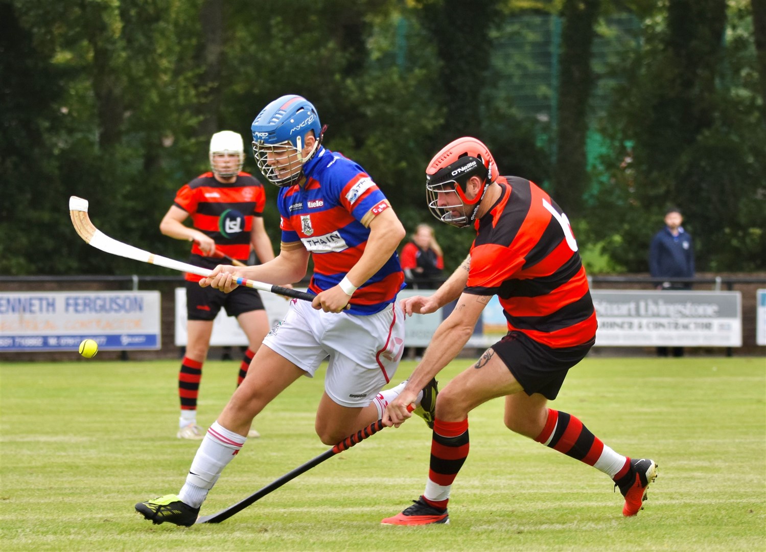 Kingussie's Iain Fraser races past Oban Camanachd's Daniel Camero. Pictures: Fiona Young.