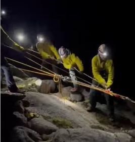 Members of the rescue team haul one of the stranded climbers to safety off The Needle.