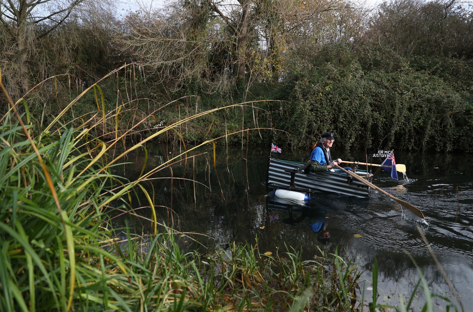 Michael Stanley, 80, rows along the Chichester canal in his home-made boat Tintanic as he nears 70 miles completed in his rowing challenge (Andrew Matthews/PA)