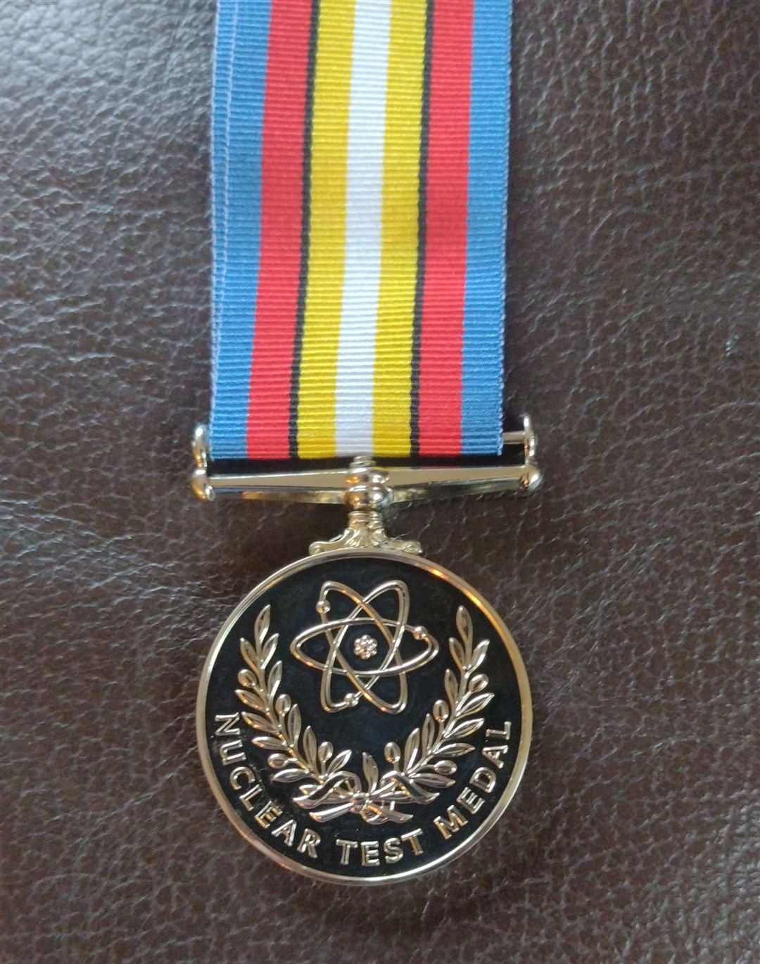 'With compliments of the Secretary of State for Defence, and the Minister for Veterans' Affairs. This Nuclear Test Medal is presented to you in recognition of the significant contribution made by your loved one to Britain's nuclear test programme.'