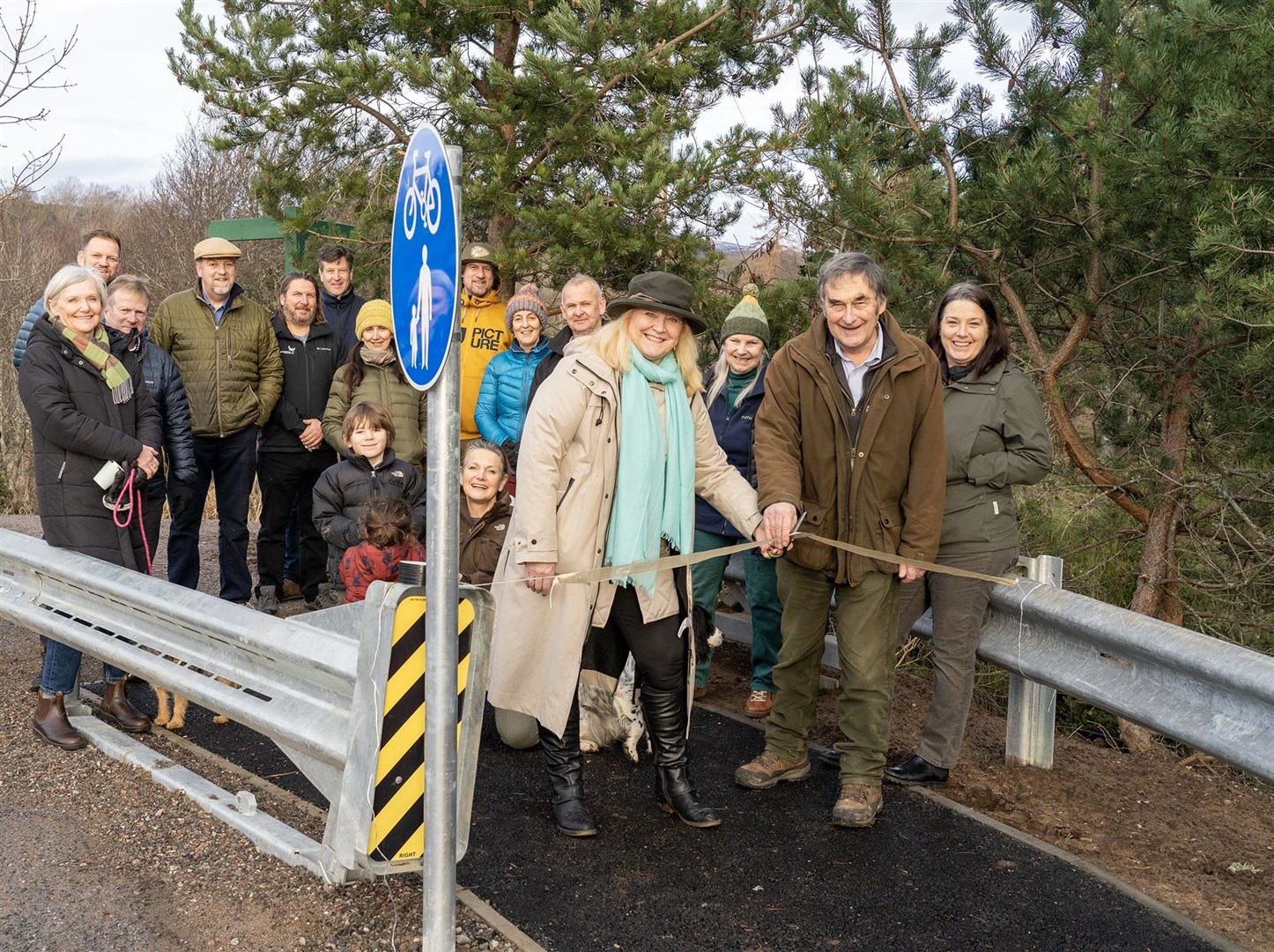 Jamie Williamson and Susan Libeks cut the ribbon and declare the new section formally open at the Spey Bridge in Kincraig