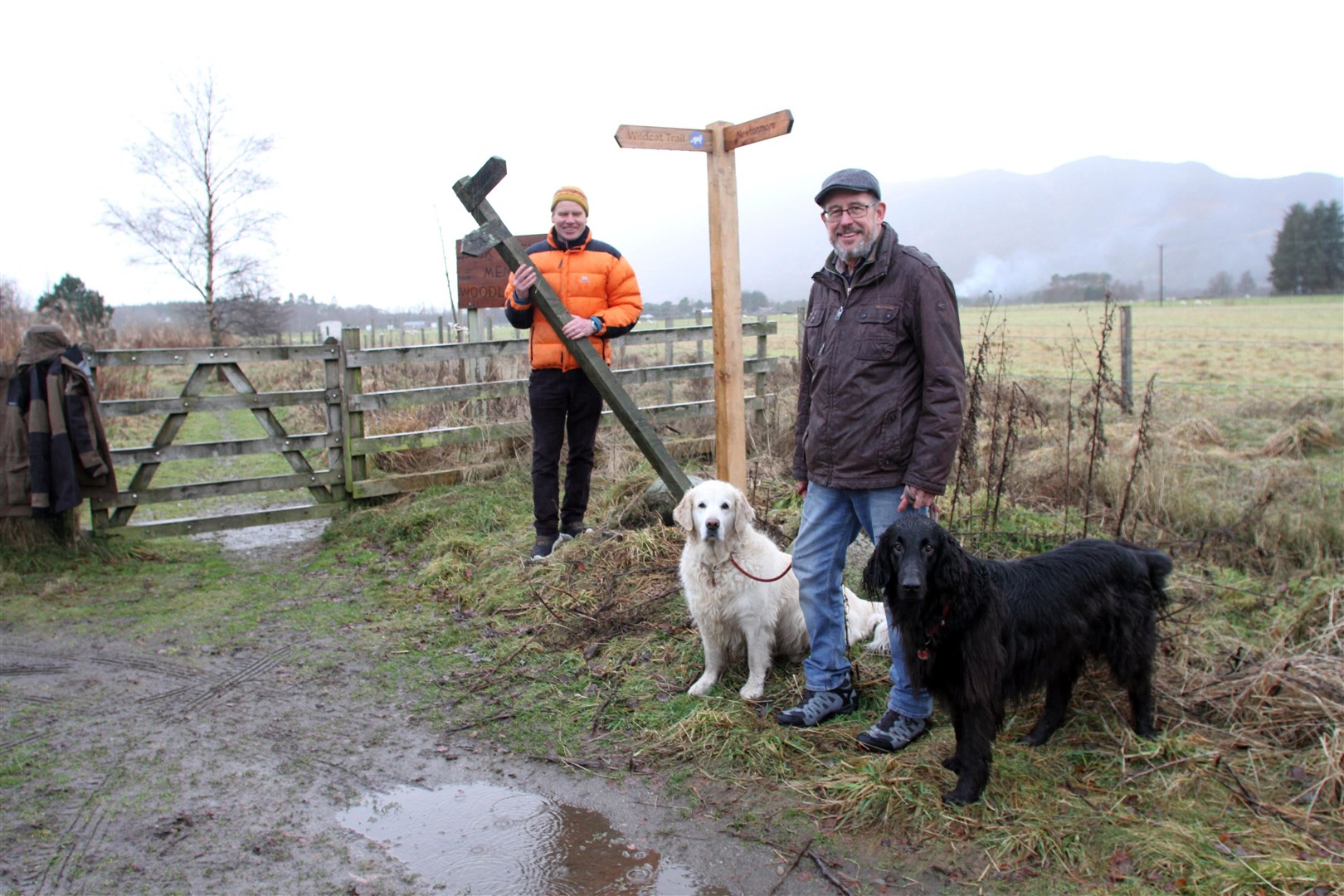 Wildcat Trail volunteers Eric Dodds and Paul Allan by one of the new signs.