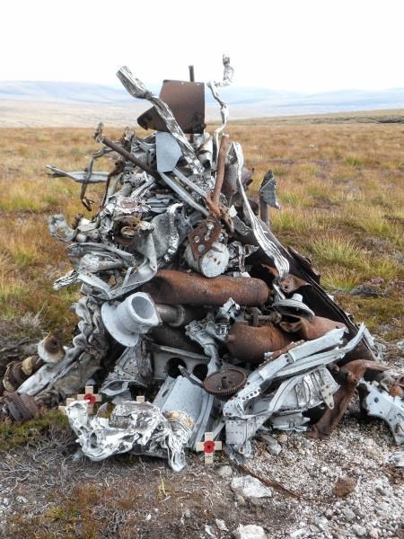 The cairn constructed from debris from the Wellington and the poppy crosses laid by the family of the pilot