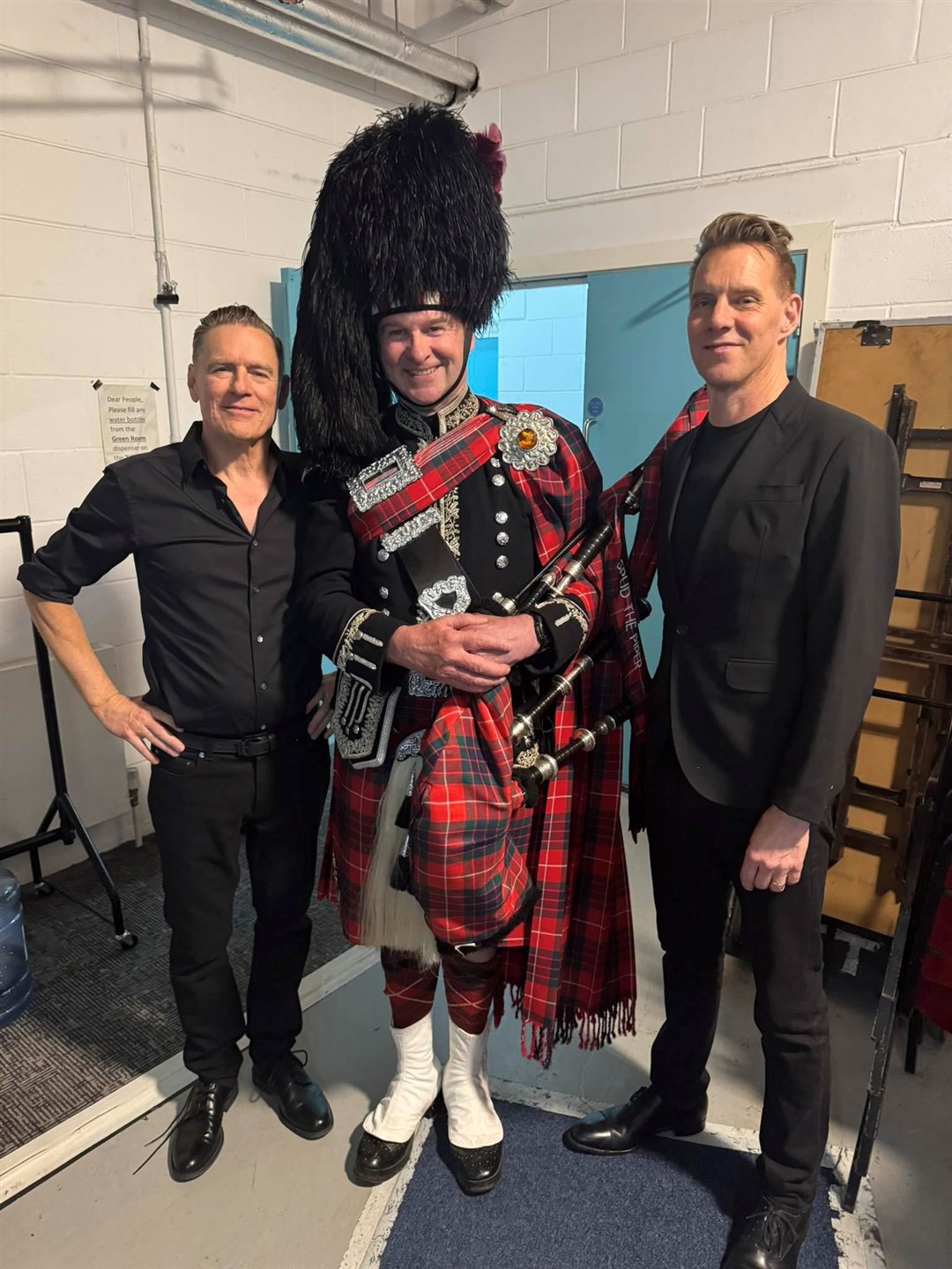 Spud the piper with Bryan Adams and (right) the rock star's keyboard ace Gary Breit