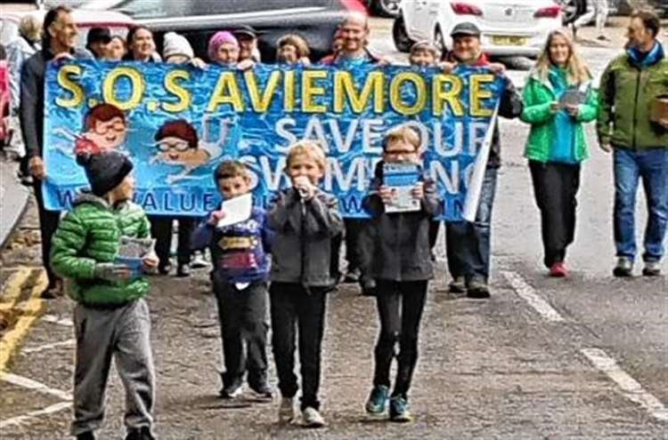 Some community campaigners march to the resort last August after the pool was closed to them.