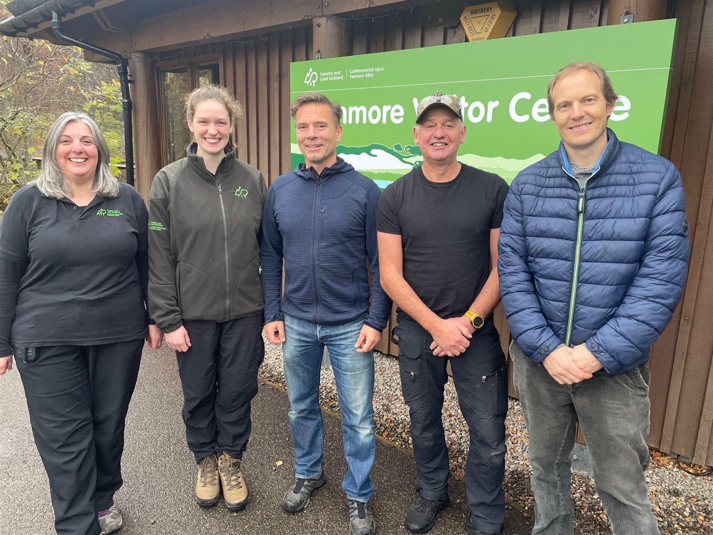 BIG DAY HAS ARRIVED: Carol MacKintosh and Laura Nicoll (both FLS) with Duncan Swarbrick, Mike Gale and Mike Dearman, of Aviemore and Glenmore Community Trust in front of the now community owned visitor centre.