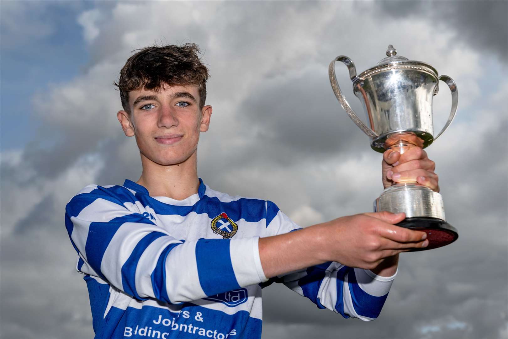 Newtonmore juniors captain Joe Coyle with the Ken MacMaster Trophy. Newtonmore v Skye Camanachd in the U14 MacMaster Cup Final, played at The Bught, Inverness.